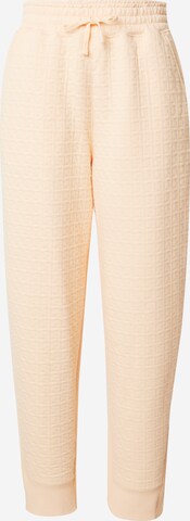 Loosefit Pantalon de sport NIKE en orange : devant