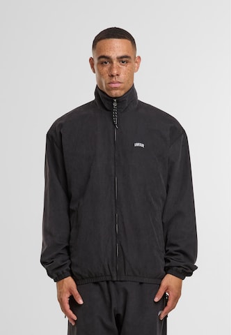 Unfair Athletics Between-season jacket in Black: front