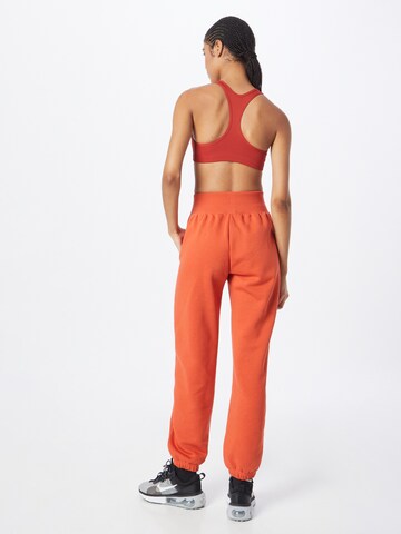 Effilé Pantalon 'Phoenix Fleece' Nike Sportswear en orange