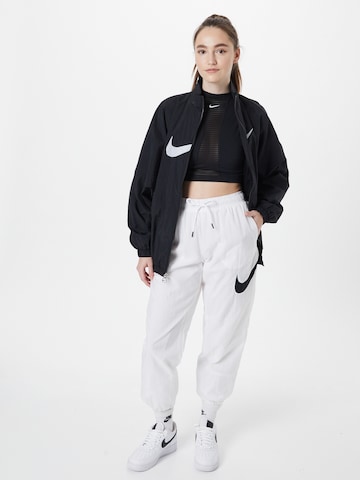 balts Nike Sportswear Pakapēniski sašaurināts piegriezums Bikses 'Essential'