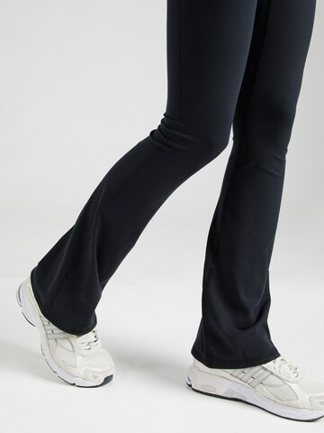 UNDER ARMOUR Flared Sports trousers 'Motion' in Black