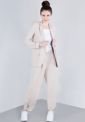 IMPERIAL Tapered Pleat-Front Pants in Beige