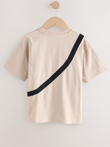 Tricou de la Next pe bej