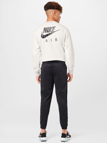 NIKE Slimfit Sportsbukser 'Challenger' i sort