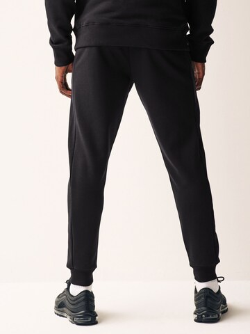 Tapered Pantaloni funzionali di Next in nero