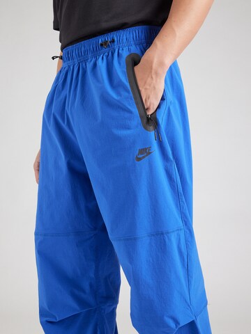 Nike Sportswear Tapered Nadrág 'Tech' - kék