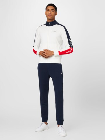 Champion Authentic Athletic Apparel Tracksuit in White: front