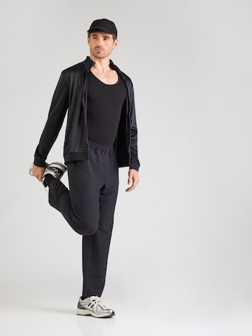 Reebok Normalny krój Spodnie sportowe 'REECE' w kolorze czarny