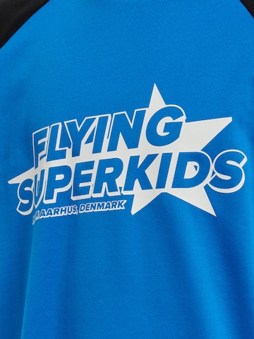 T-Shirt 'FLYING CHAMPION' Hummel en bleu