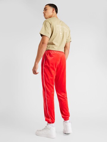 Nike Sportswear Tapered Trousers in Red