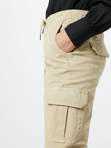 Tapered Pantaloni cu buzunare de la Urban Classics pe bej