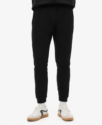 Superdry Tapered Trousers in Black: front
