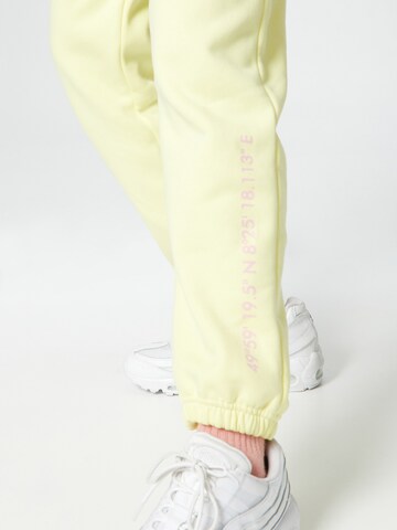 ABOUT YOU x Mero Loose fit Trousers 'Code' in Yellow