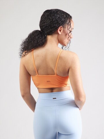 Bustino Reggiseno sportivo 'Bloom' di Athlecia in arancione