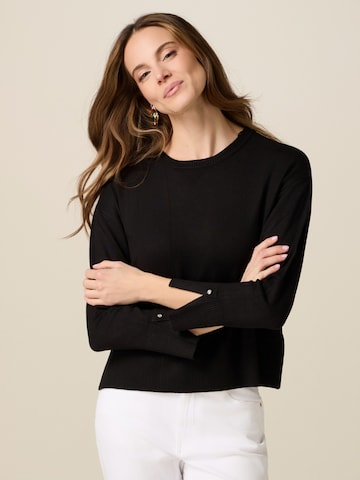 Pullover di oltre in nero: frontale