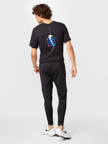 NIKE - Tapered Calças de desporto em preto