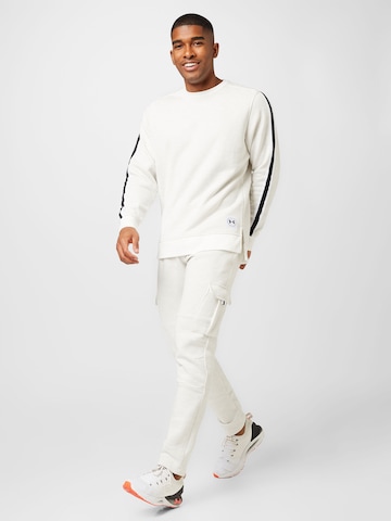UNDER ARMOUR Tapered Sports trousers in White