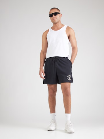 Loosefit Pantalon 'Club' Nike Sportswear en noir