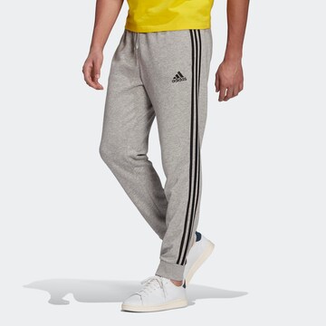 Tapered Pantaloni sport 'Essentials French Terry Tapered Cuff 3-Stripes' de la ADIDAS SPORTSWEAR pe gri: față