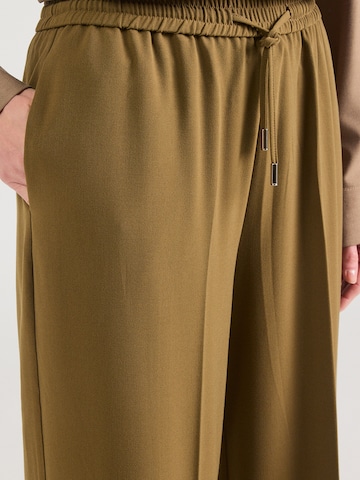 žalia ABOUT YOU Standartinis Kelnės su kantu 'Melody'