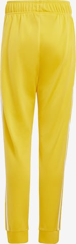 ADIDAS ORIGINALS Tapered Pants 'Adicolor SST' in Yellow