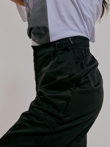 ABOUT YOU x Chiara Biasi Loose fit Pants 'Cleo' in Black