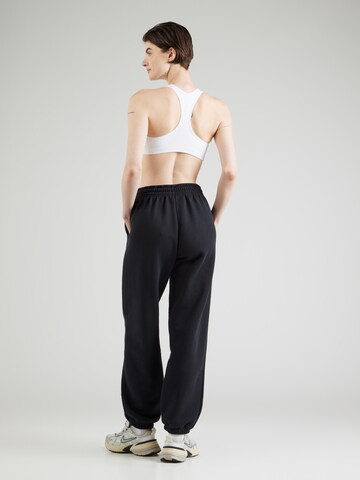 Nike Sportswear Tapered Housut 'Phoenix' värissä musta