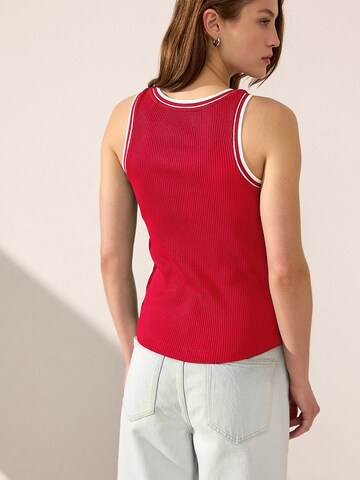 Haut Next en rouge