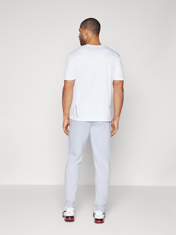 PUMA - Tapered Pantalón deportivo 'ESS 2 No. 1' en gris