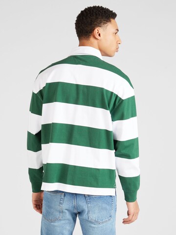 Tommy Jeans T-shirt 'VARSITY' i grön