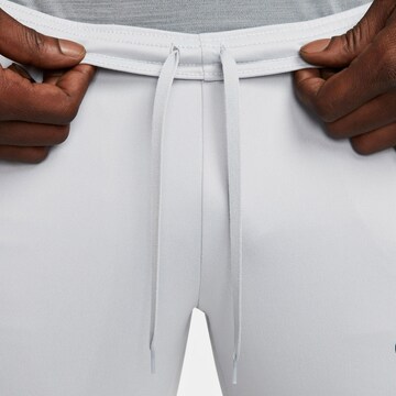 NIKE Slim fit Workout Pants 'Academy' in Grey