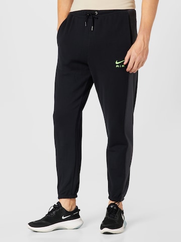 Nike Sportswear Tapered Trousers in Black: front