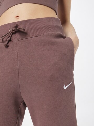 purpurinė Nike Sportswear Siaurėjantis Kelnės 'Phoenix Fleece'