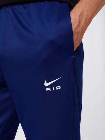 zils Nike Sportswear Pakapēniski sašaurināts piegriezums Bikses