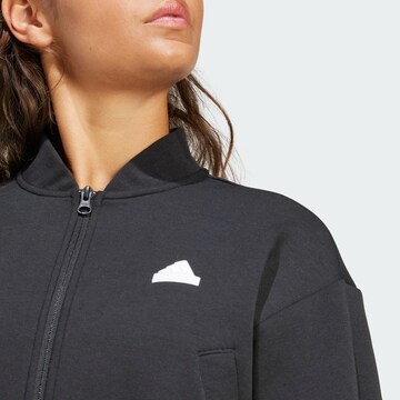 ADIDAS SPORTSWEAR Спортна жилетка с качулка 'Future Icons' в черно