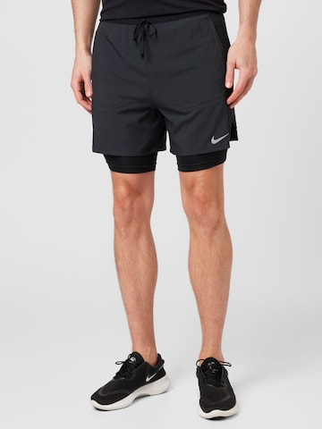 NIKE Slim fit Sports trousers in Black: front