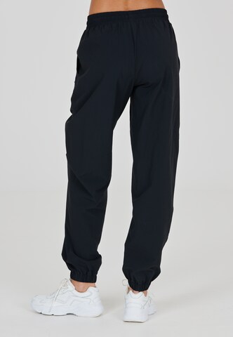 Athlecia Tapered Sports trousers 'Hero' in Black