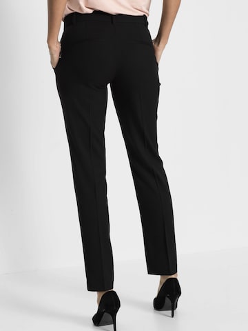 Slimfit Pantaloni di bonprix in nero