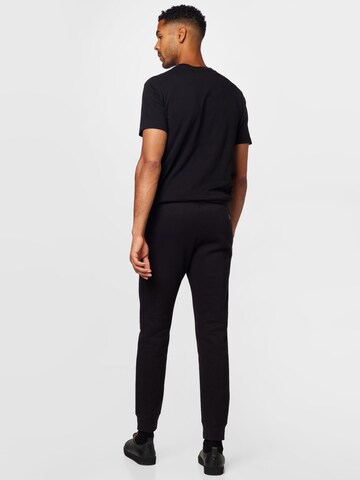 Tapered Pantaloni di Champion Authentic Athletic Apparel in nero