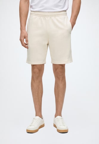 Regular Pantaloni de la Karl Kani pe bej: față
