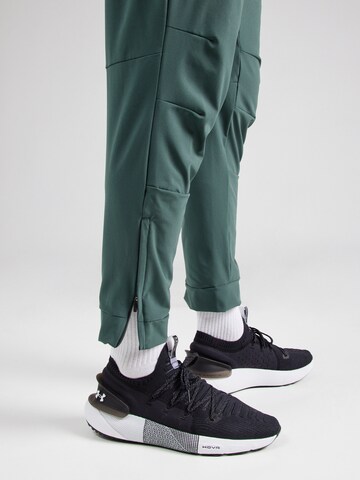 NIKE Конический (Tapered) Спортивные штаны 'UNLIMITED' в Зеленый