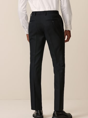 Skinny Pantaloni con piega frontale di Next in nero