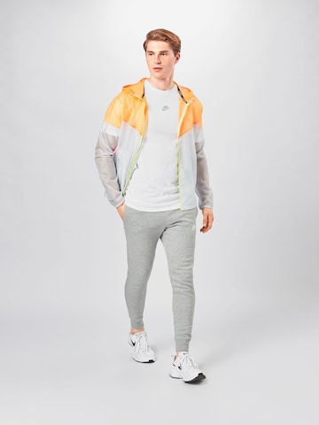 Nike Sportswear Tapered Housut 'Club Fleece' värissä harmaa