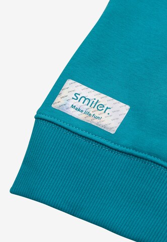Sweat 'Happy' smiler. en bleu