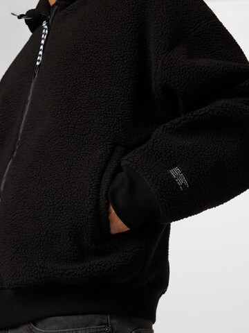 LEVI'S ® Fleecejacke 'Sherpa Full Zip Hoodie' in Schwarz