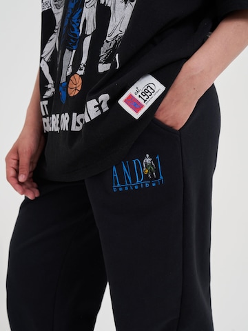 AND1 Tapered Funktionshose in Schwarz