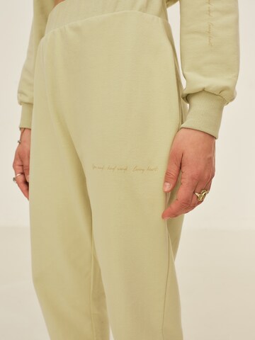 ABOUT YOU x Sofia Tsakiridou Regular Trousers 'Nora' in Green