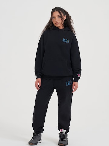 AND1 Tapered Funktionshose in Schwarz