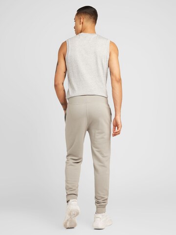 Effilé Pantalon 'Legacy' Champion Authentic Athletic Apparel en gris