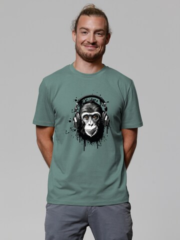 Maglietta 'Affe hört Musik' di Watapparel in verde: frontale